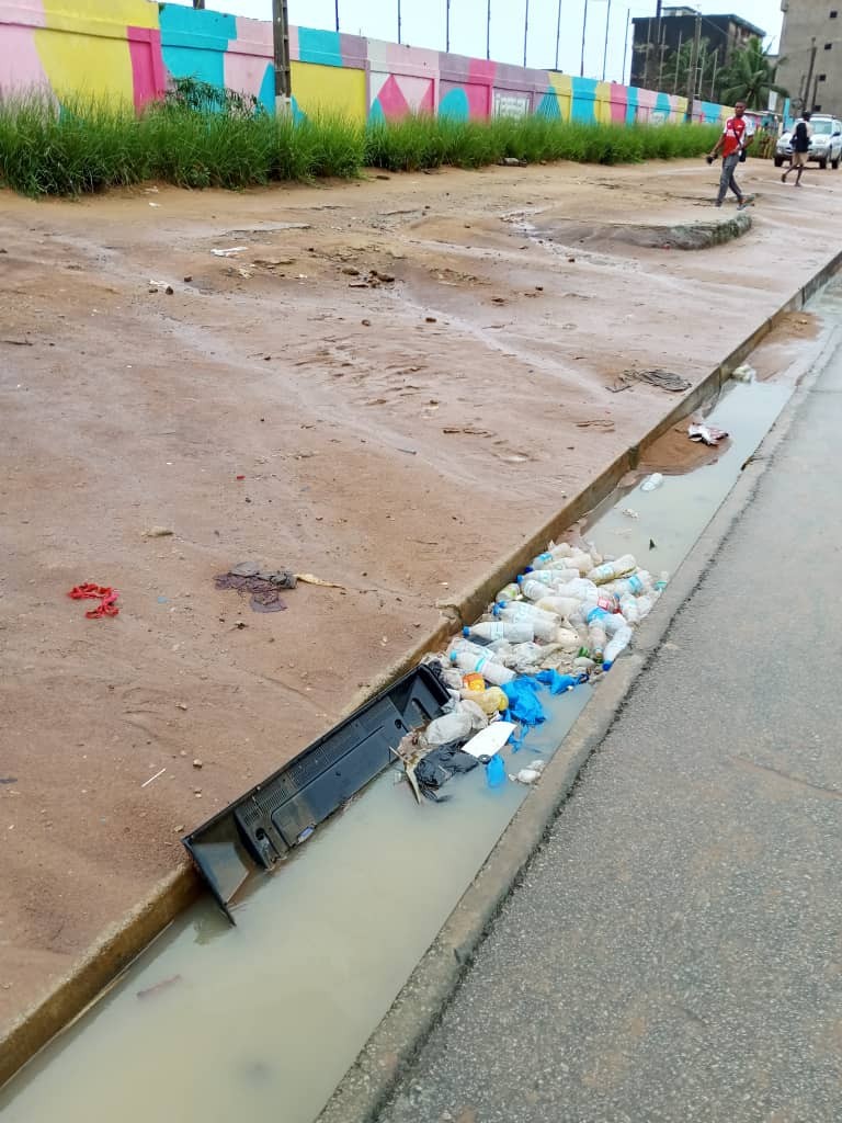 Caniveau obstrué avec déchets plastiques